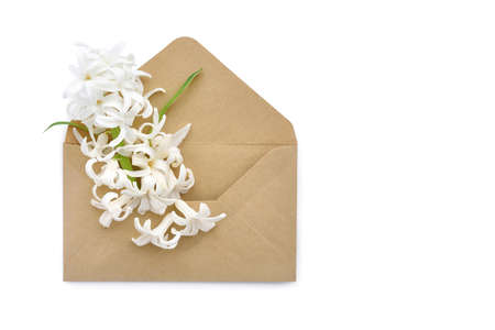 A envelope with a spring flower arrangement on white background. Flat lay, top view.の写真素材