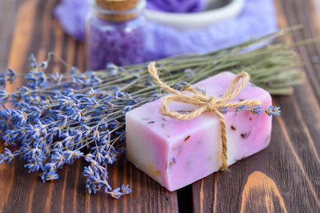 Lavender spa products on wooden table. Body care products with lavender: soap, salt and dried lavender flowers. Selective focus.の写真素材