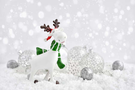 Christmas decorations little figure elk with festive decorations Ð¾n the snow. Christmas or New Year greeting card.の写真素材