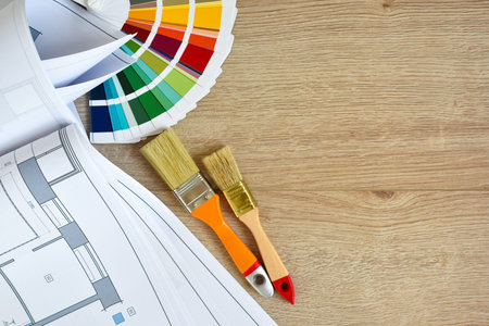 Architectural drawings with color guide, brushes on wooden background. top view. Space for your...