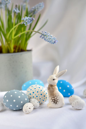 Easter composition with white rabbit, eggs and spring flowers. Easter still life