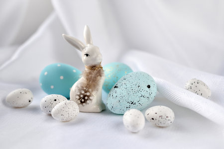 Easter composition with white rabbit and eggs on a white background. The minimal concept.の写真素材