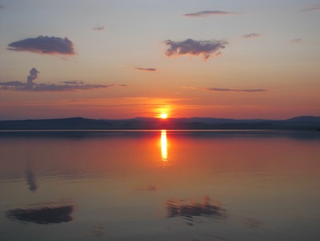 the sun sits down in the lakeの写真素材