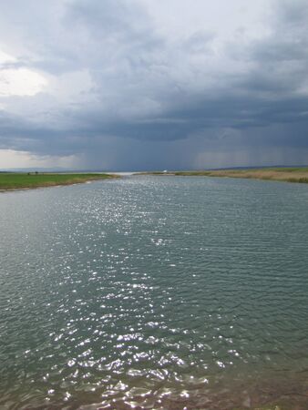 the storm sky over the lakeの写真素材