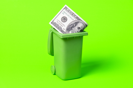 Money trash can isolated on green background.の写真素材