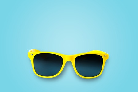 Yellow glasses isolated on a blue background, vacation, vacation, summer, sunの写真素材