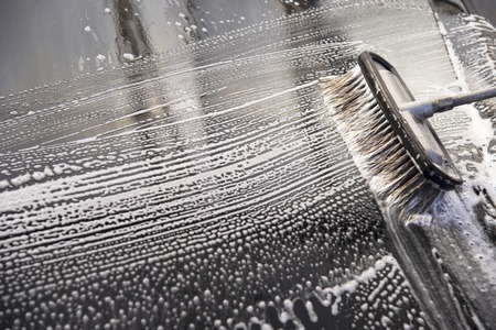 Brush for cleaning glass. Car wash with a brush, hand washの写真素材