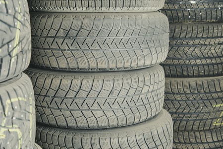 Old and used car tires. Background. Car tires in storage. Car tire recyclingの写真素材