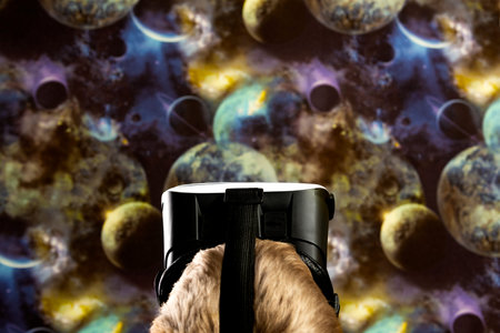 A boy looks into space through virtual reality glasses. Space background