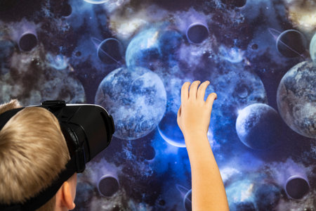 childhood, augmented reality, technology and people concept - boy with virtual headset or 3D glasses...