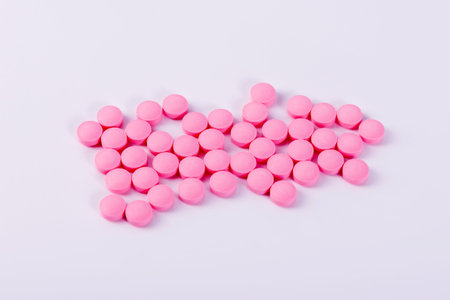 Pink round pills on a white background. View from aboveの写真素材