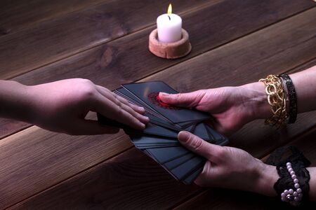 Fortune telling cards, runic cards for divination on a wooden table. Fortune-telling accessories. Top view, place for text.の写真素材