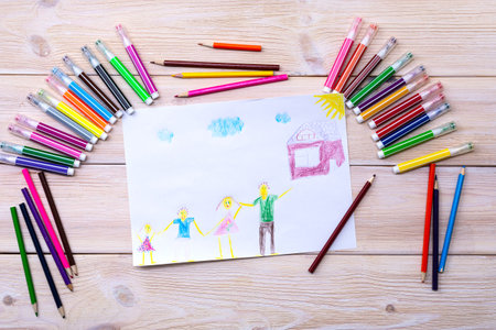 The drawing was made by a child using colored markers and pencils. Children's drawing of a family,...