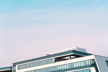 the upper part of the city office building against the blue sky, urban architecture.の写真素材