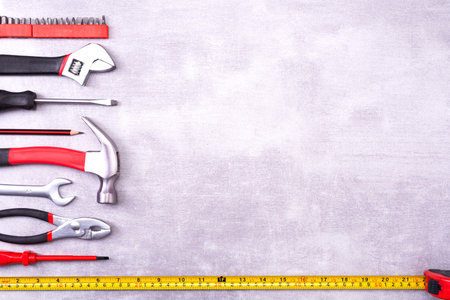 Various repair tools on a gray background. Equipment for construction. Repair tool kit. Top view...
