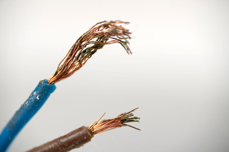 White wire without insulation for power supply close-up. Broken electrical wire