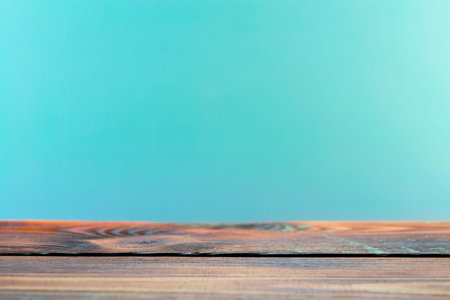 Wooden board empty table in front of a blurred background. Perspective brown wood with a blurry multi-colored background - can be used to showcase or assemble your products. Mock upの写真素材