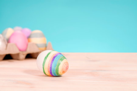 Colorful easter eggs on a stand on a table on a blue background.の写真素材