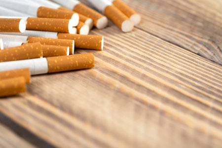 cigarettes on wooden background, close-up of a cigarette with place for text.