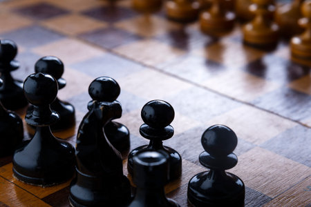 chess on a chessboard, black pawns against white.の写真素材