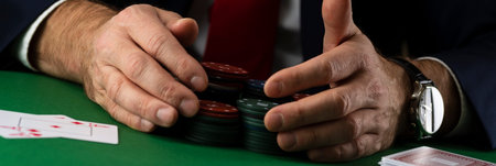 Businessman at green playing table with gambling chips and cards playing poker and blackjack in...