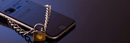 Minsk, Belarus - 01 31 2021: Browsing the Clubhouse app on a smartphone, a controversy of 2021 hiding behind the Social app. Lock on the phone as a symbol of a closed application.のeditorial素材