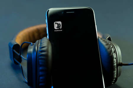 Minsk, Belarus - 02.21.2021: View of the Clubhouse app on a smartphone, a controversy of 2021 hidden behind the Social app. The fall of the club in the audio chat application on the smartphone.のeditorial素材