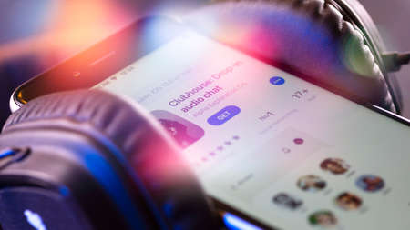 Minsk, Belarus - 02.21.2021: View of the Clubhouse app on a smartphone, a controversy of 2021 hidden behind the Social app. The fall of the club in the audio chat application on the smartphone.の写真素材
