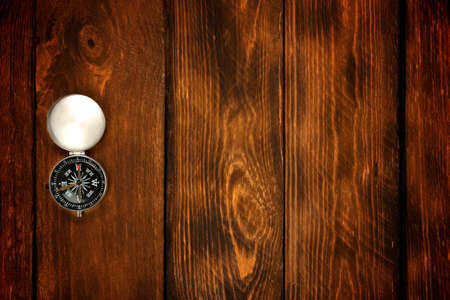 compass on the brown wooden table background.の写真素材