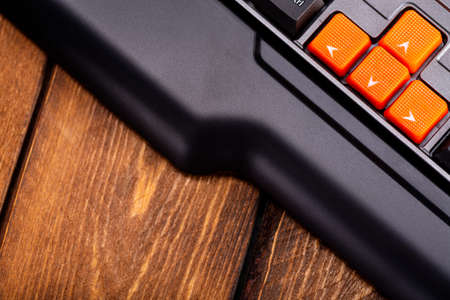 Orange arrow keys on a black keyboard, up, down, left, right buttons on a gaming computer keyboard.の写真素材
