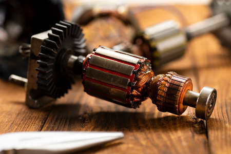 Power tool repair. Details of electrical appliance and repair tools on a wooden table in a repair shopの写真素材