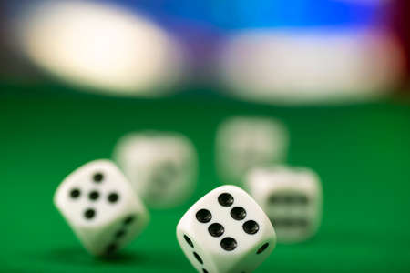 White dice on green felt table close upの写真素材