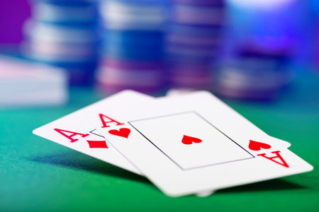 Two aces and stack of Casino Chips in background