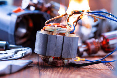 Power tool repair. Details of electrical appliance and repair tools on a wooden table in a repair shopの写真素材