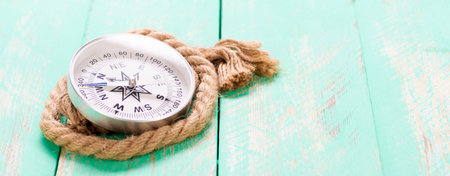 Compass and rope on wooden texture backgroundの写真素材