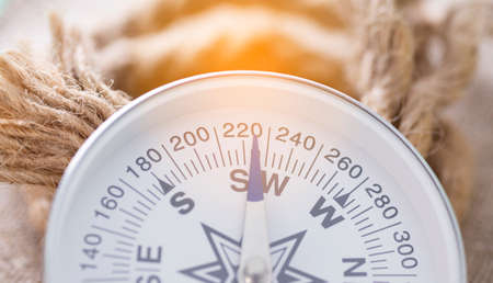 Close-up of compass with sun glare and ropeの写真素材