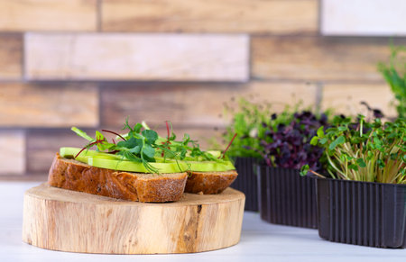 Sandwiches with microgreens and avocado on the table. Healthy eating concept of clean food