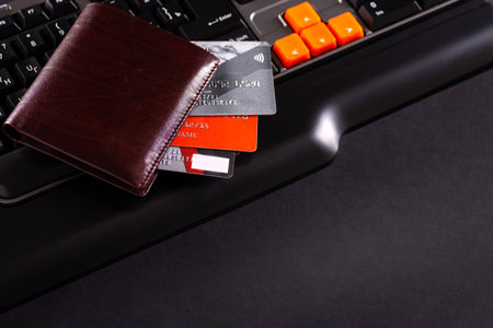 Conceptual view of on-line shopping with credit card,wallet and laptopの写真素材