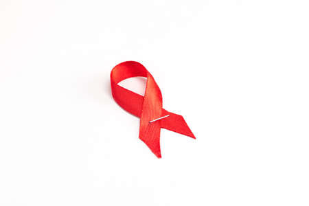 Health care and medicine concept. AIDS awareness. Red awareness ribbon on white background. International AIDS Dayの写真素材