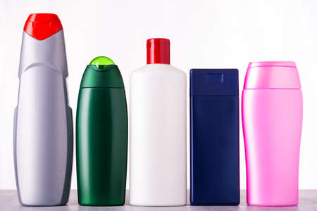 Multicolored bottles with hygiene products on table on white backgroundの写真素材