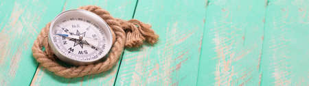 Compass and rope on wooden texture backgroundの写真素材