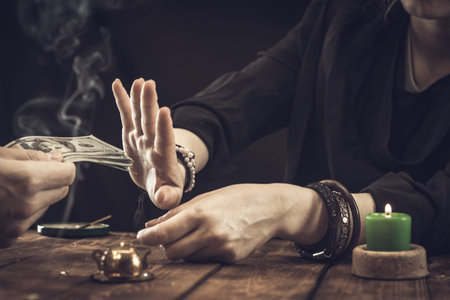 A fortune teller or oracle in search of the lines of fate in the palm of a person. Fortune telling...