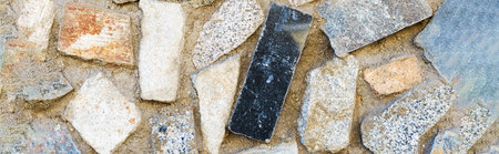 Close-up of a fragment of an old natural stone wall.