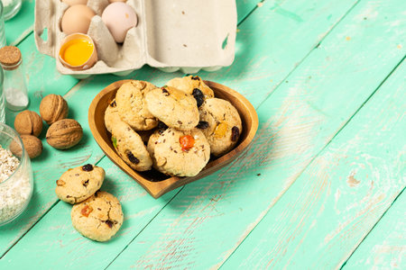 Cooking oatmeal cookies with candied fruits and walnuts. Eggs, oatmeal, flour, sugar, spices and...