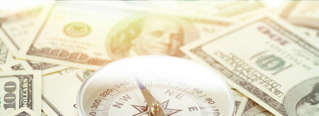 Travel compass on the background of American dollars. Travel concept, travel cost.の写真素材