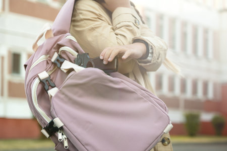 firearms at school. A teenager with a gun on the background of the school. A man goes to school with a gun. school violence.の写真素材