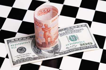 Russian rubles and American dollars on a chessboard.の写真素材