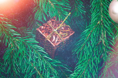 Christmas gift on the background of the Christmas tree close-up.の写真素材