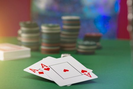 Two aces and stack of Casino Chips in backgroundの写真素材