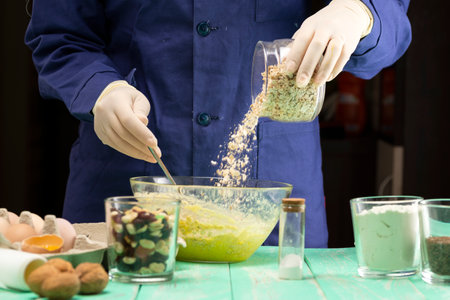 Cooking oatmeal cookies with nuts and candied fruit sweet nutritious dessert.の写真素材